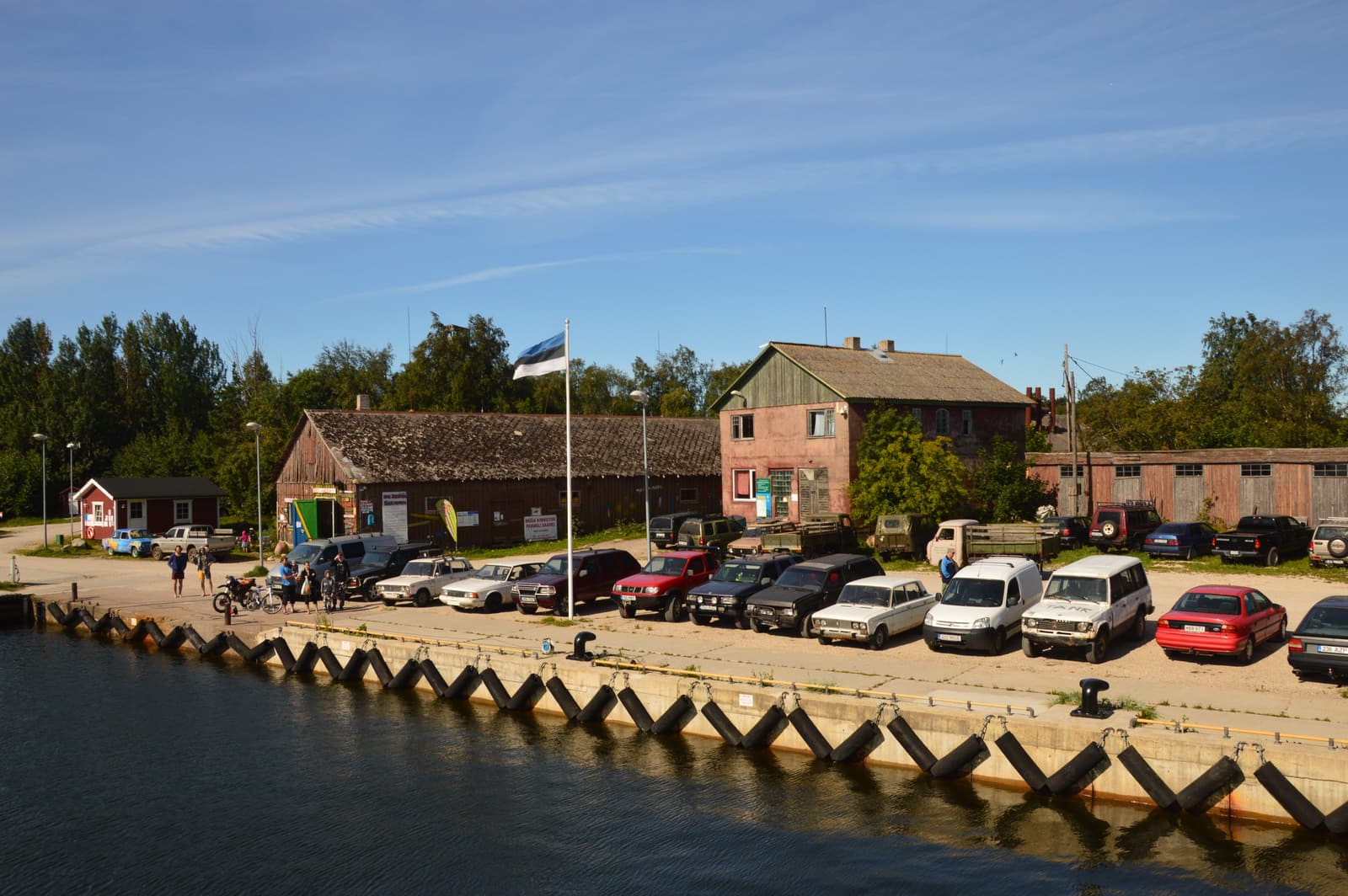 Kelnase harbour on Prangli island with red harbour buildings and the Estonian flag