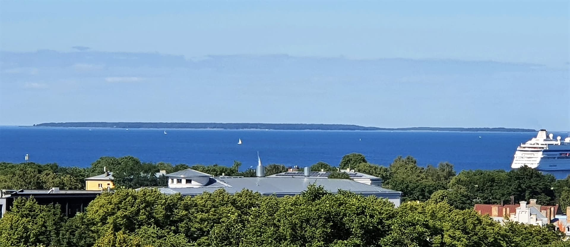 Naissaar seen as a long forested island across the sea from Tallinn