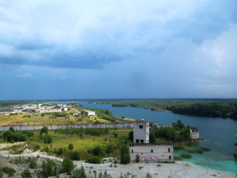 The flooded Rummu quarry with a half-submerged building, seen from above